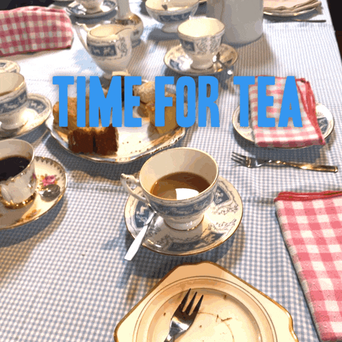 a table with cups and saucers and the words time for tea written in blue