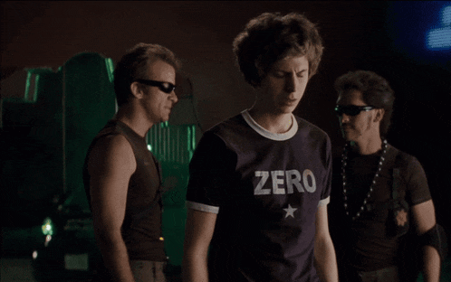 a man wearing a purple shirt that says zero on it