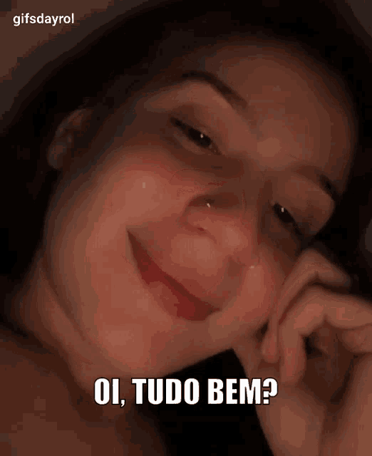 a close up of a woman 's face with the words ol tudo bem written above her