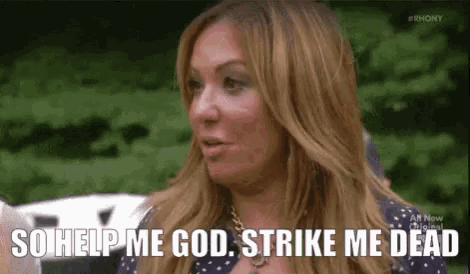 a woman is sitting on a bench talking to someone and saying `` so help me god , strike me dead '' .