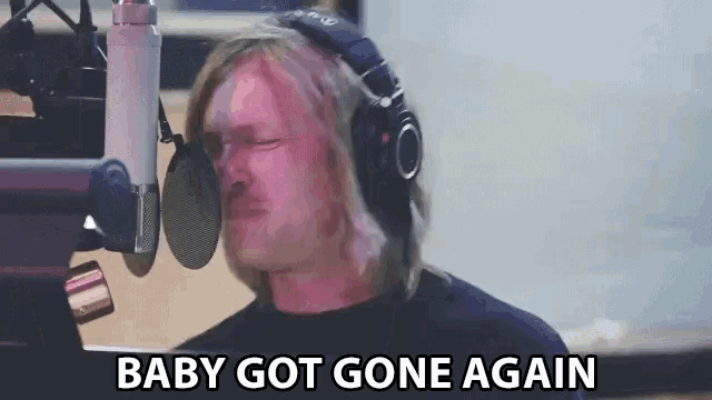 a man singing into a microphone with the words baby got gone again written below him