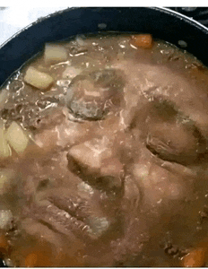 a close up of a pot of soup with a face on it .