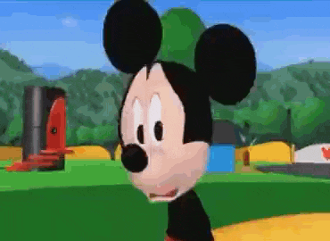 a close up of mickey mouse 's face with trees in the background