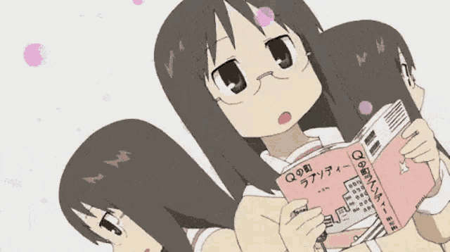 a girl with glasses is holding a book with japanese writing on it
