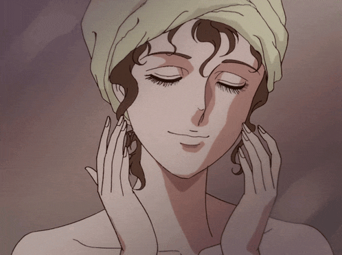 a woman with a towel wrapped around her head is touching her face with her hands