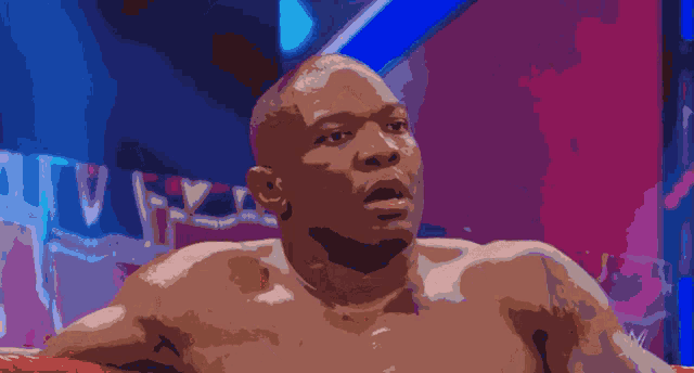 a man without a shirt has a w logo on his chest