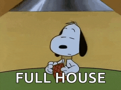snoopy is sitting at a table holding a piece of meat and saying full house .