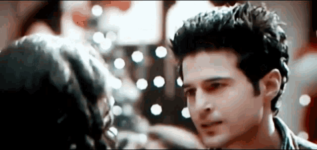 a man and a woman are looking into each other 's eyes .