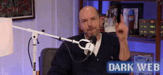 a man giving a middle finger in front of a microphone with the words dark web written on the bottom