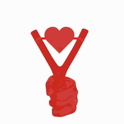 a hand is holding a catapult with a red heart on it