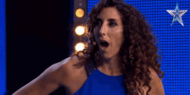 a woman with a surprised look on her face in front of a star