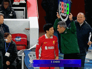 a soccer player in a red jersey with the number 3 on the back