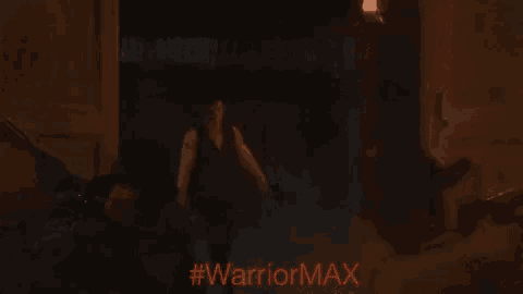 a man with his arms outstretched has #warriormax written on the bottom of the image
