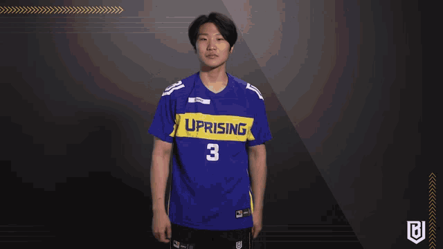 a man wearing a blue shirt that says uprising on it