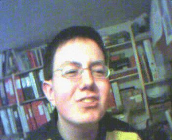 a blurry picture of a man wearing glasses