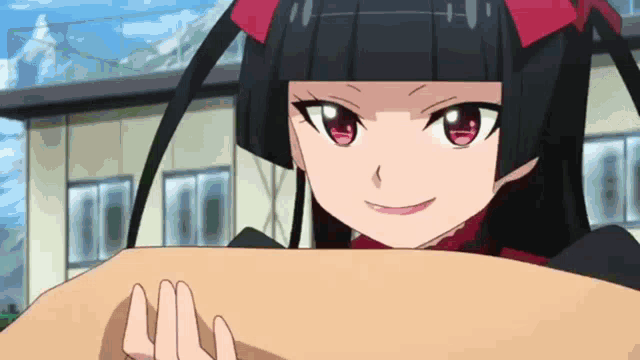 a girl with black hair and red eyes is holding a piece of paper in front of her face .