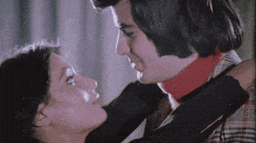 a man and a woman are looking at each other