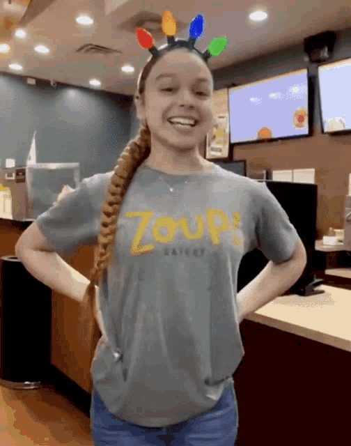 a girl wearing a t-shirt that says zoup eatery
