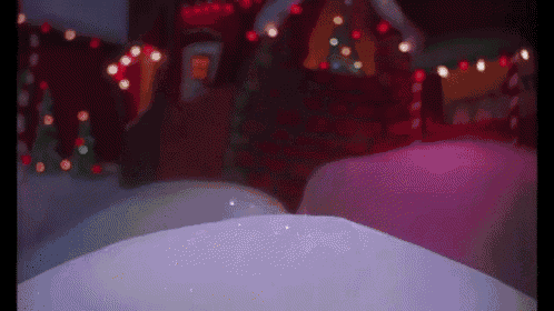 a person is standing in the snow in front of a christmas scene .