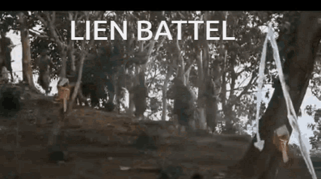a group of people are standing in a forest with the words lien battel written on the bottom of the screen .
