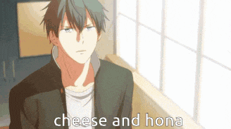 a man in a suit is standing in front of a window with the words `` cheese and hona '' written on it .