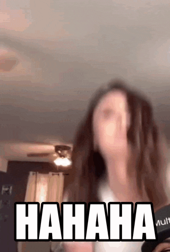 a blurry picture of a woman laughing with the words hahaha written in white
