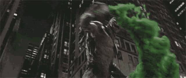 a statue of a monster is surrounded by green smoke coming out of it 's mouth .
