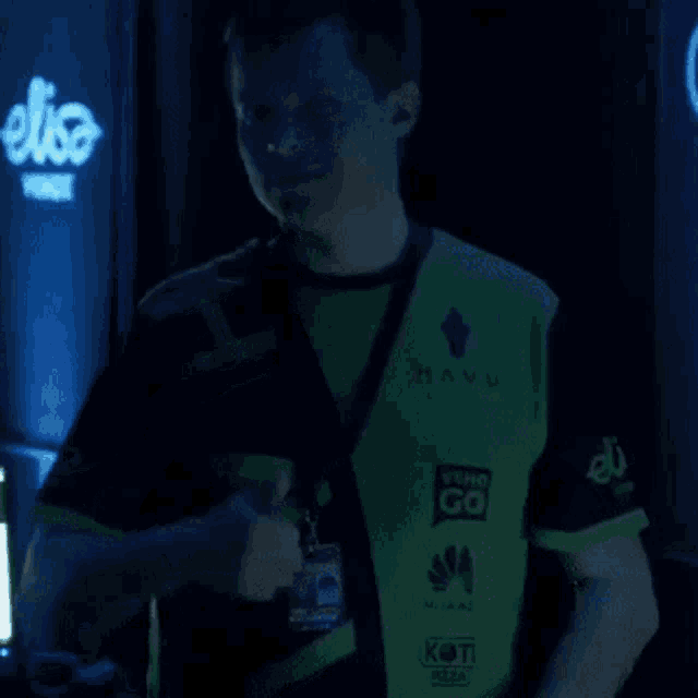a man wearing a vest that says " huawei " on it