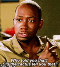 a man in a green shirt is talking to another man .