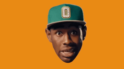 a man wearing a green hat with the number 0 on it is covering his mouth with his hand