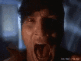 a close up of a man with his mouth open in the dark .