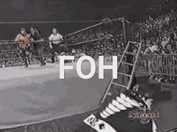 a black and white photo of a wrestling match in a ring with the words `` foh '' written on it .