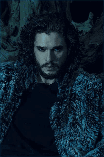 a man with long hair and blue eyes is wearing a blue fur coat