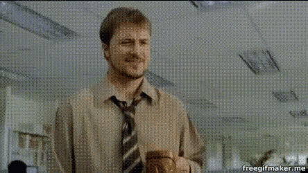 a man in a suit and tie is holding a cup of coffee .
