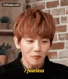 a young man with red hair is making a face and saying `` i fearless '' .