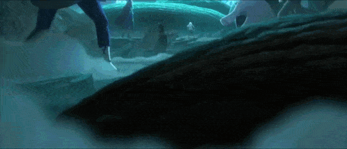 a group of people are standing in a dark cave surrounded by ice and water .