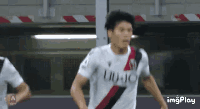 a soccer player wearing a shirt that says ' imago ' on it
