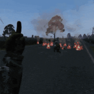 a person giving a thumbs up in front of a fire