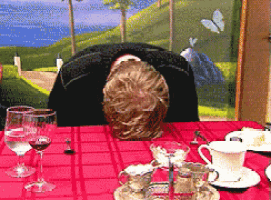 a person sitting at a table with a red table cloth