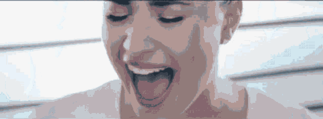a woman is screaming with her mouth open and her eyes closed .