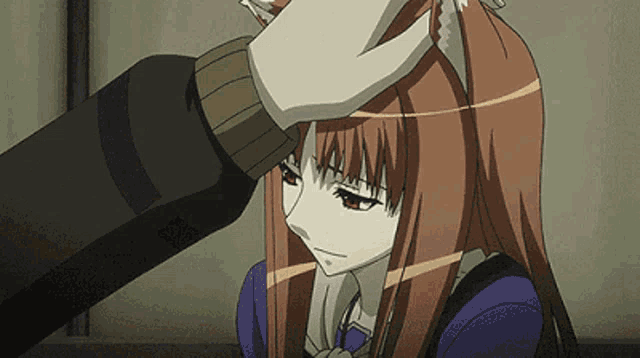 a person petting a girl 's head with a fox ear