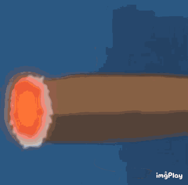 a close up of a man eating a piece of meat from a stick .