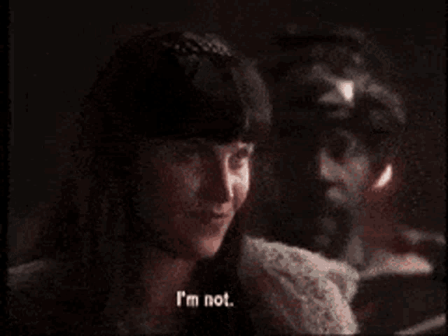 a woman says yeah gabrielle in front of a man in a dark room