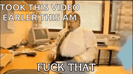 a man is sitting at a desk in front of a computer with a caption that says took this video earlier this am fuck that
