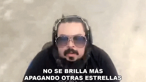 a man with a mustache and sunglasses is wearing headphones and making a funny face .