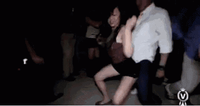 a man and a woman are dancing in a dark room .