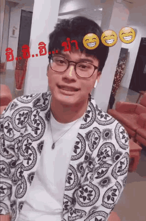 a man wearing glasses and a paisley jacket is smiling with smiley faces around him