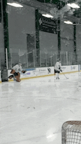 a hockey game is being played in a stadium with a banner that says ' a ' on it