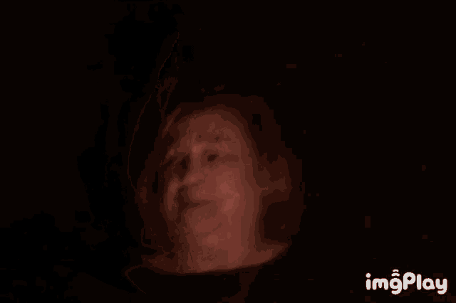a close up of an older woman 's face with a shocked look on her face .