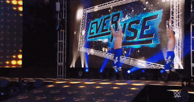 wrestlers on a stage with the word everise behind them